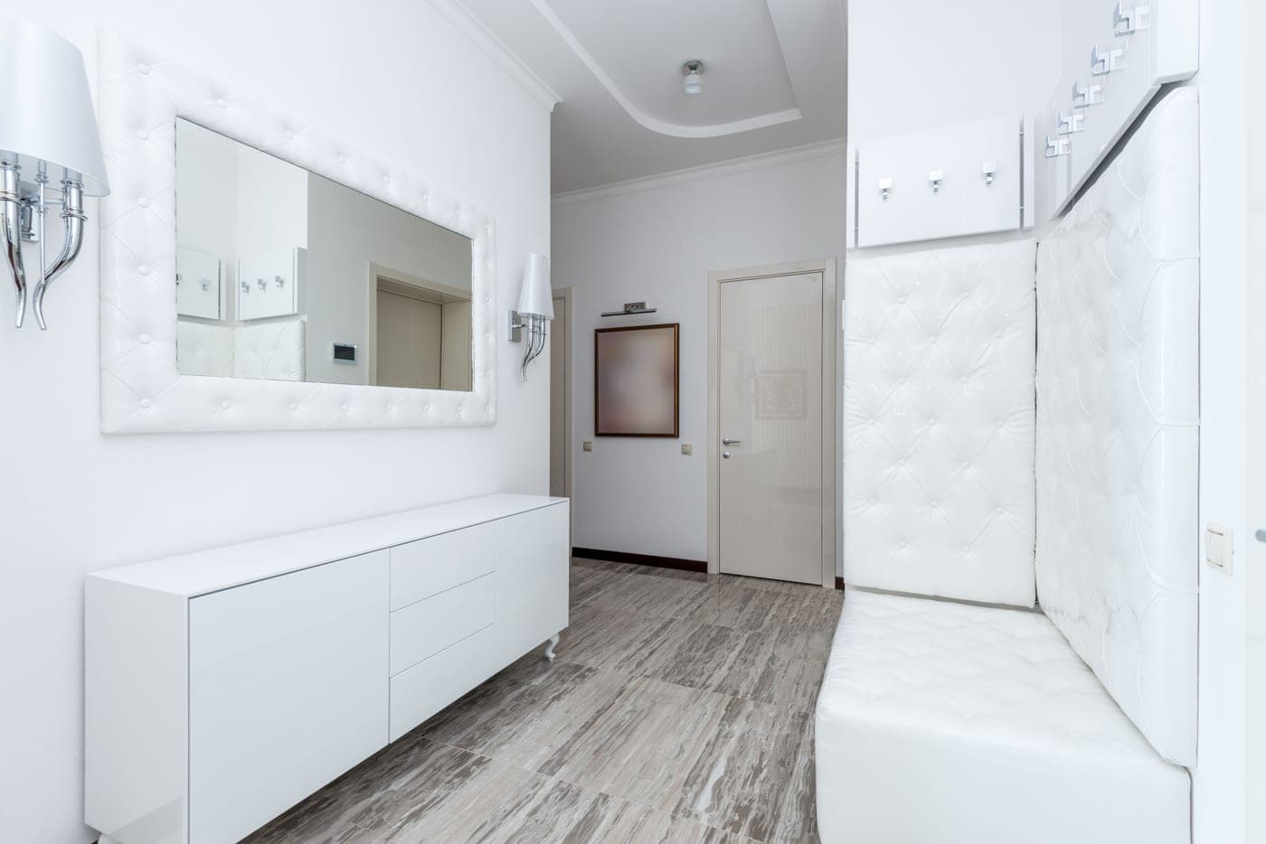 A bright hallway with modern storage furniture along one wall