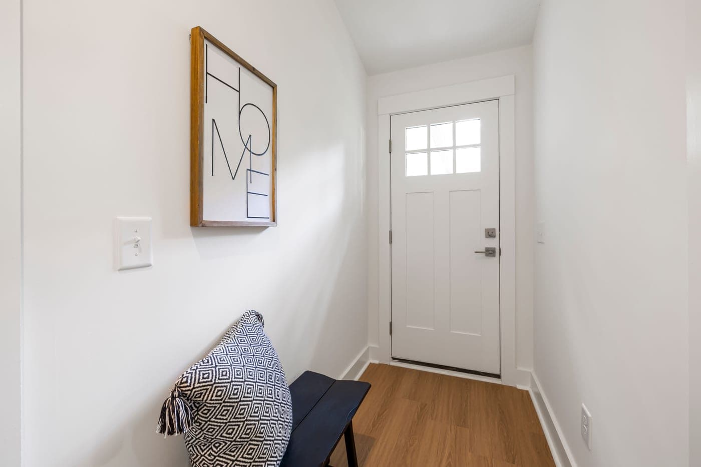 A wide bench running along a hallway wall