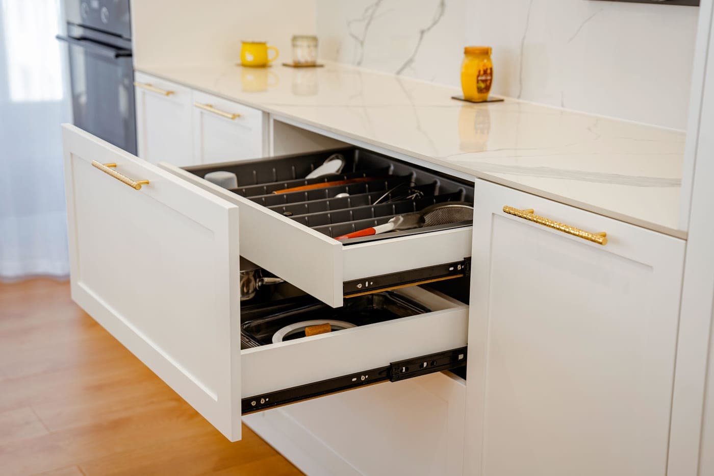 An open cabinet drawer with shoes stored inside it