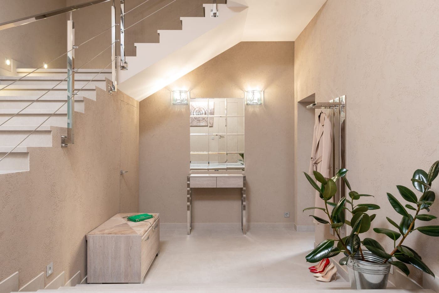 A narrow entry hall with a mirror above a slim console