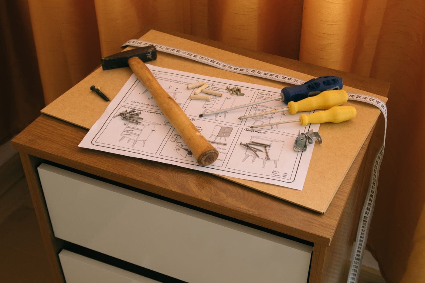 Furniture parts, tools and screws laid out during assembly
