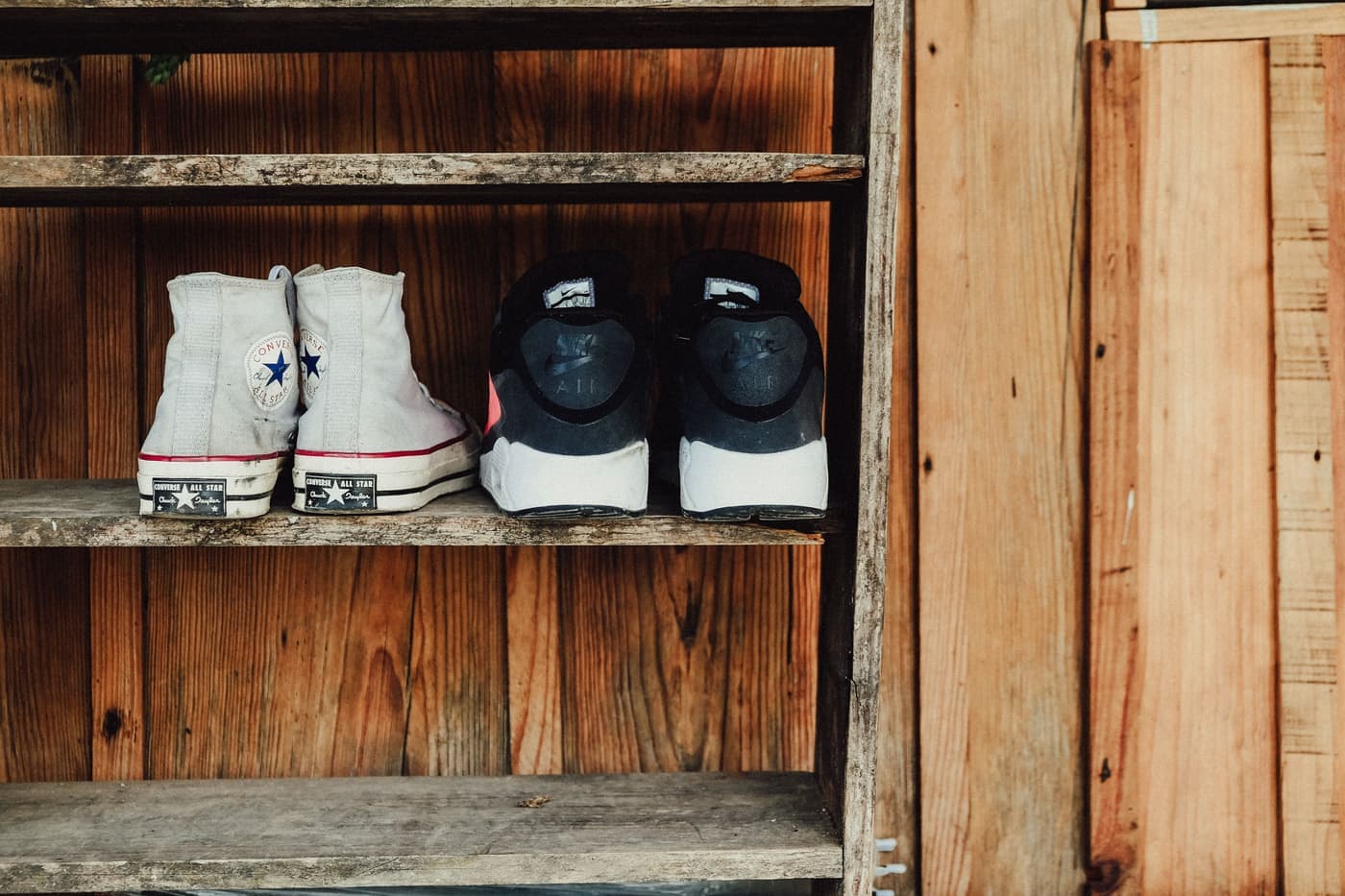 Shoes displayed on a rustic wooden shelf