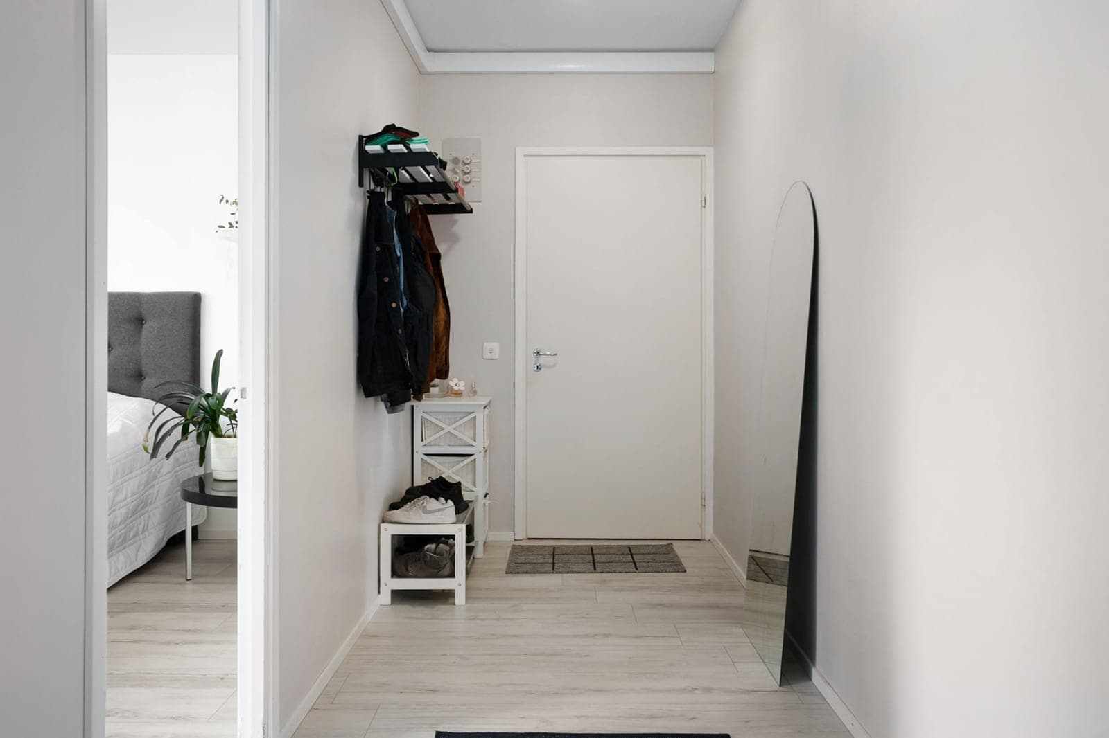 A minimalist hallway with white walls and simple furnishings