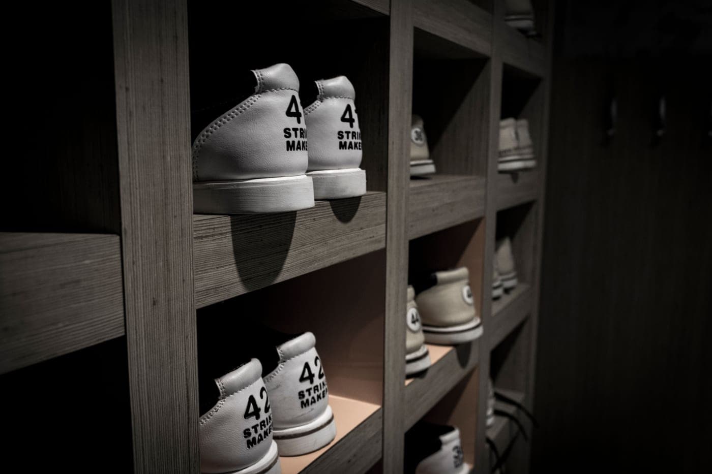 White sneakers neatly organized on wooden shelves
