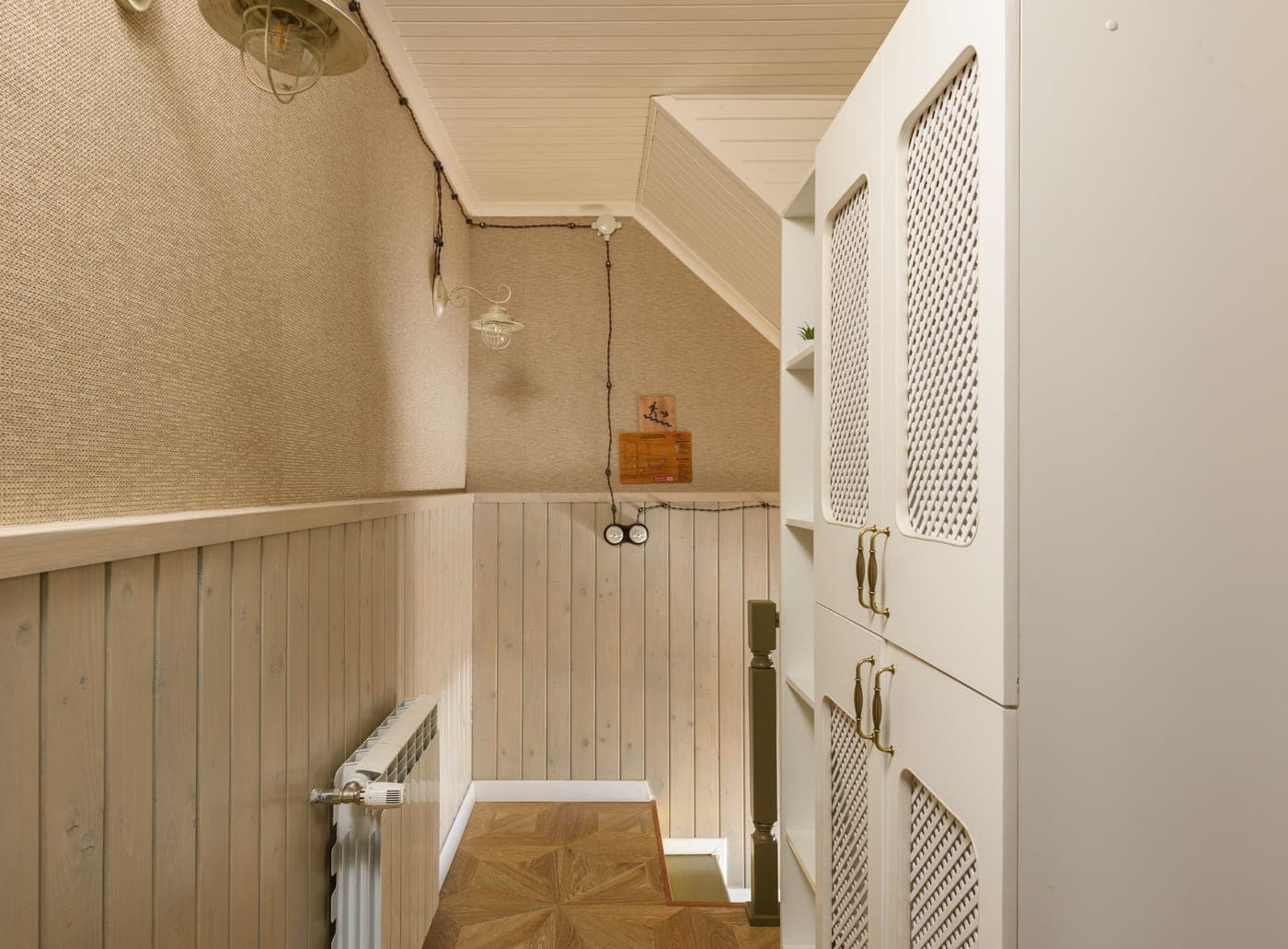 A slim white shoe cabinet standing flush against a narrow corridor wall